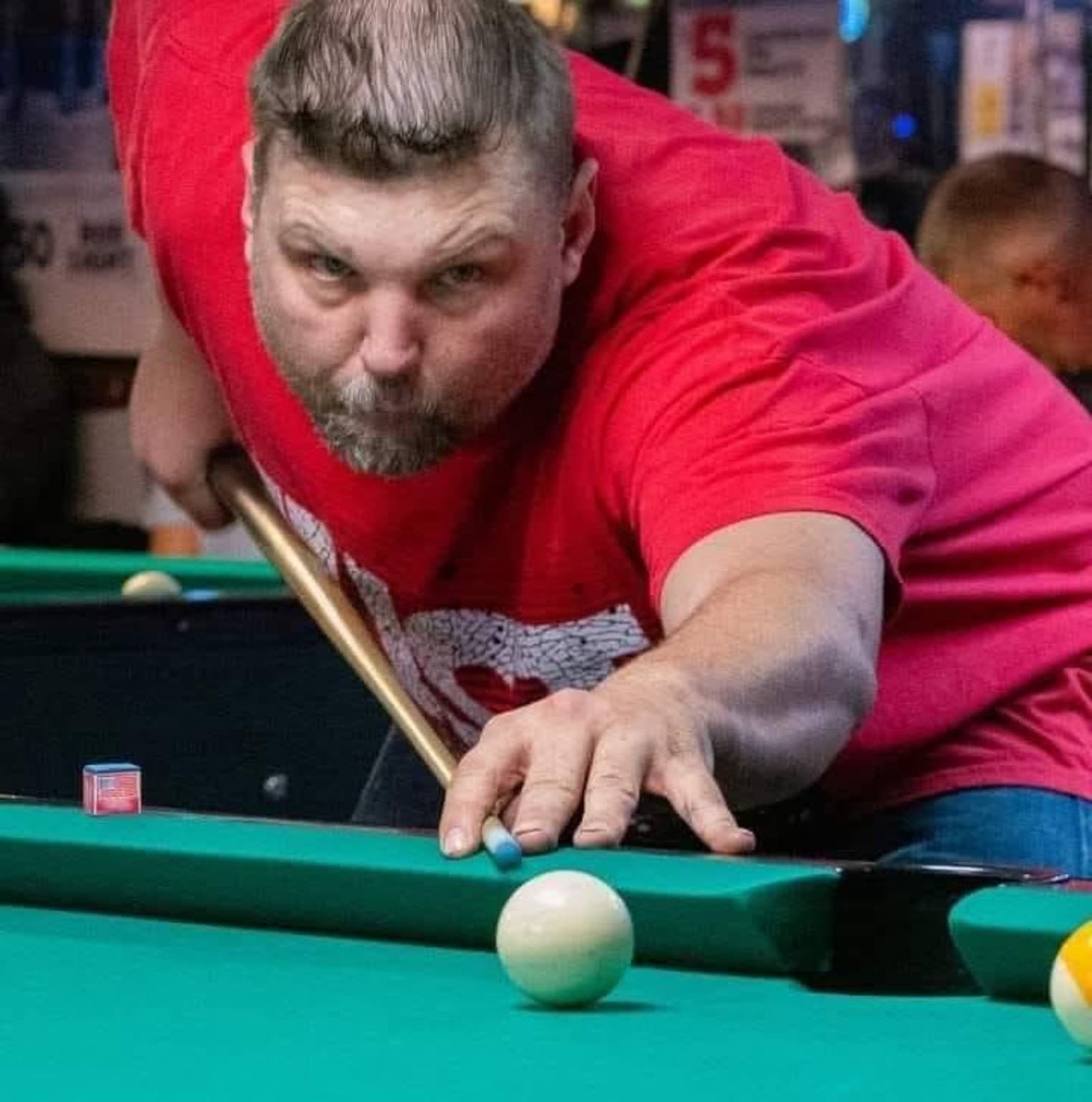 Joseph Dankowski lining up a pool shot